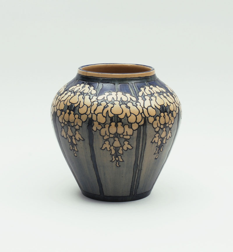 Newcomb College - Vase with a design of conventionalized wisteria blossoms, 1904. Designed and executed by Mazie T. Ryan. Potted by Joseph F. Meyer.   Glazed earthenware.