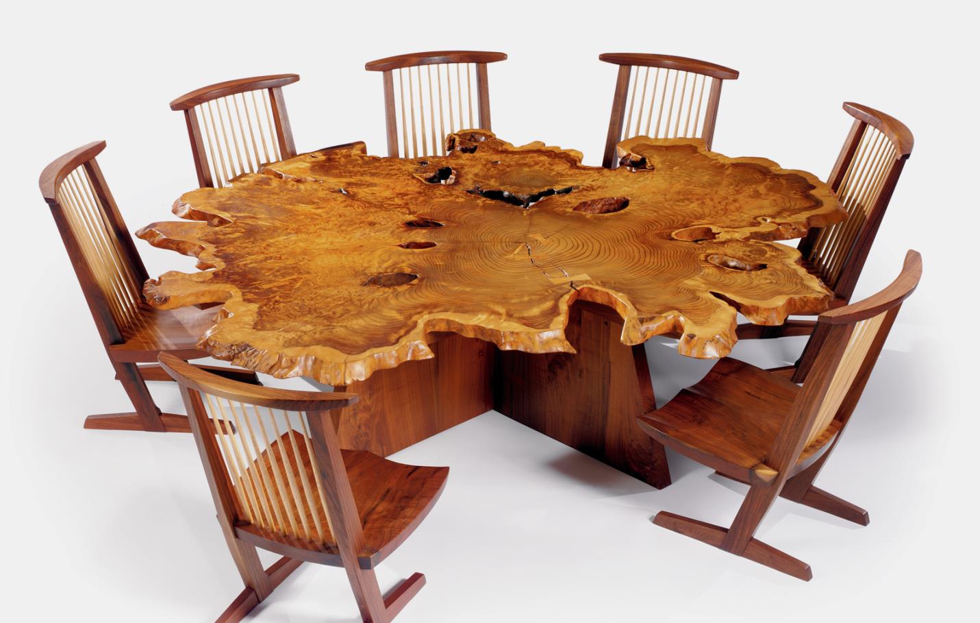 George Nakashima's “Arlyn” table - redwood, black walnut, madrone burl, and east indian laurel; 26” x 89” x 91”. Conoid chairs - walnut and hickory; 35 ½” x 20” x 21”.