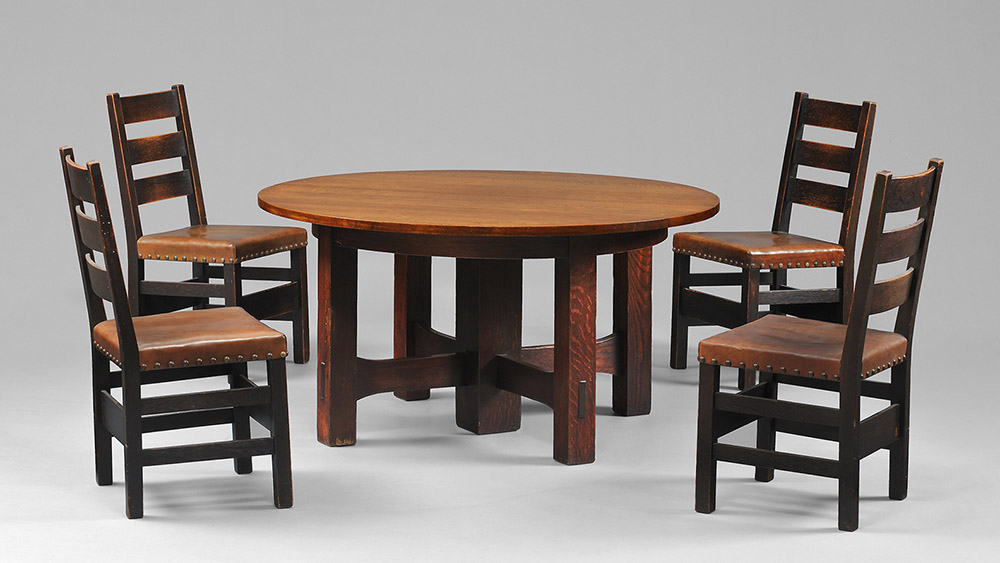 Fig. 1 - Dining table (model no. 634), c. 1912-1914, and set of four side chairs (no. 349 ½), c. 1905-1907. Craftsman Workshops, Eastwood, NY, manufacturer. Oak, leather, brass nails. Table: 30 x 54 inches diam.; chairs 37 ½ x 18 ¼ x 18 ½ inches each. TRRF Collection.