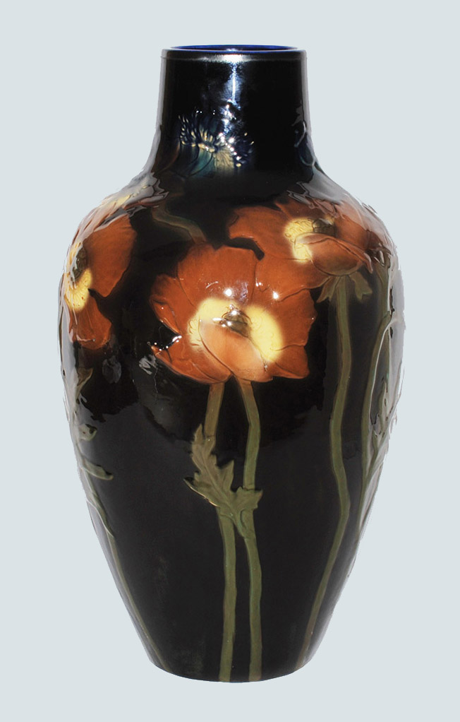 Fig. 7 - Carved black iris vase with poppies, 1900. Matthew Andrew Daly, American, 1860-1937, designer and maker. Rookwood Pottery Company, Cincinnati, OH, manufacturer. Glazed stoneware. 21 ½ inches high. TRRF Collection.
